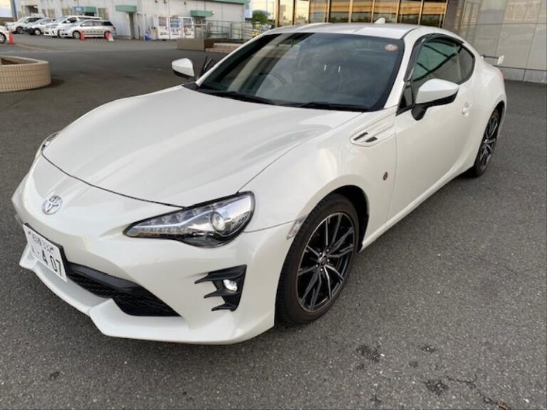 Side view of a well-maintained 2016 Toyota 86 sports car, featuring a sleek, aerodynamic design, bold front grille, and stylish alloy wheels